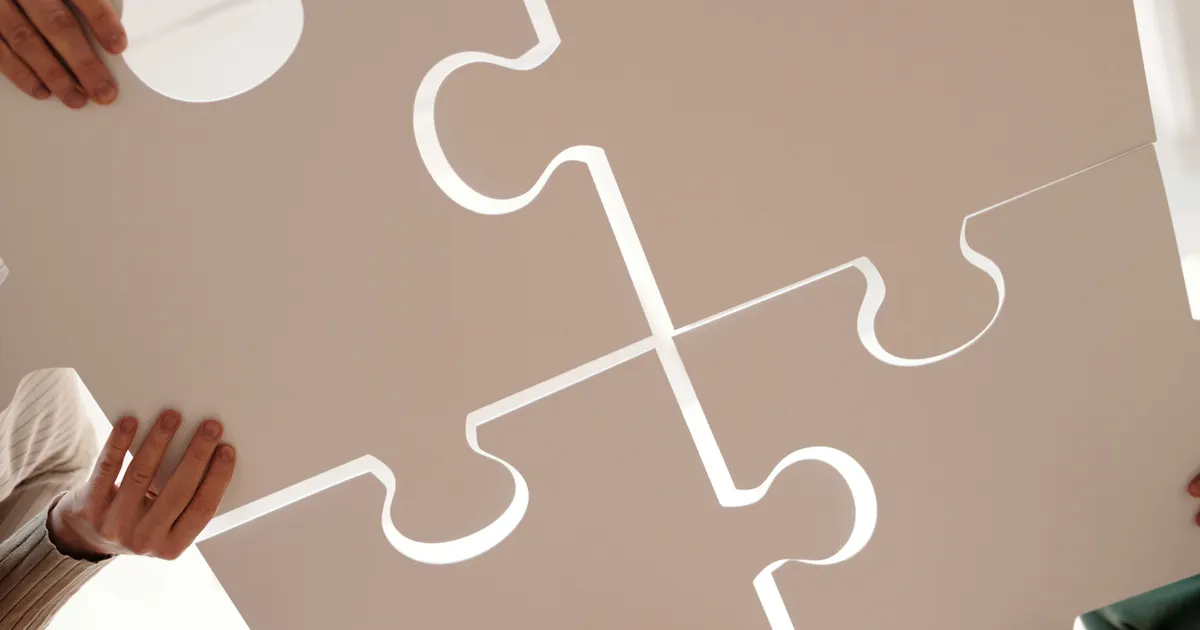 Hands of diverse individuals holding large puzzle pieces, symbolizing…, illustrating the section “Architecture: hubs, links and the orphan problem”