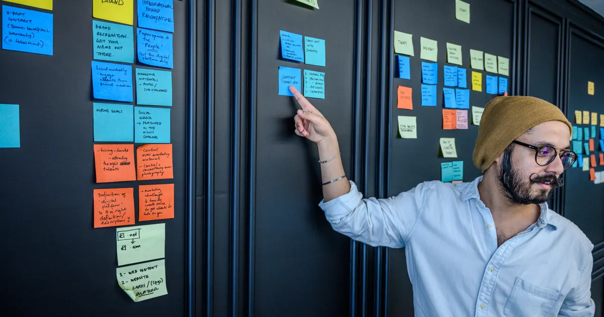 Des post-it qui couvrent un mur pendant un atelier d'idées, en illustration de la définition SEO de Difficulté d'un mot-clé